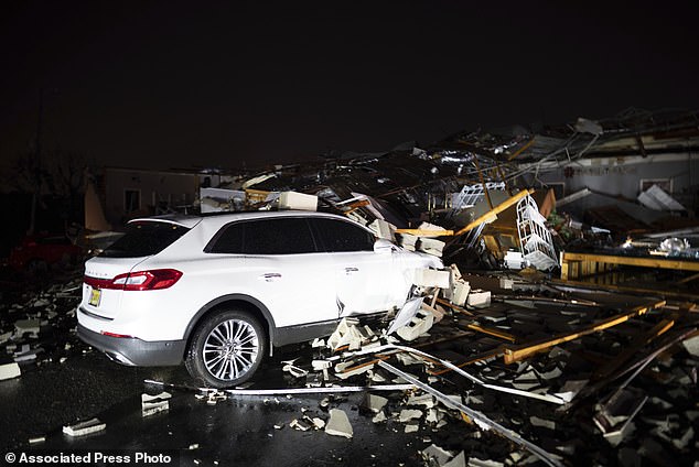 A car is buried under rubble on Main Street after an apparent tornado struck Hendersonville