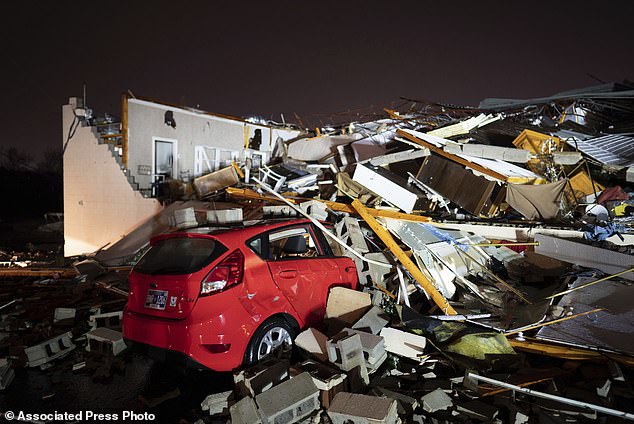 A car is buried under rubble on Main Street after a tornado struck Hendersonville