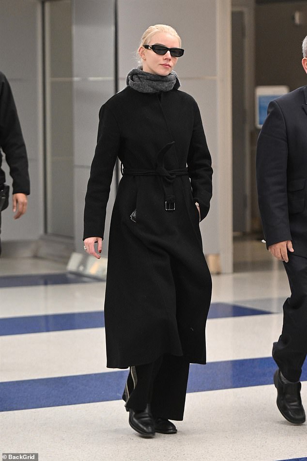 The 27-year-old Golden Globe winner wore a long black coat, slacks and boots with a gray scarf wrapped around her neck