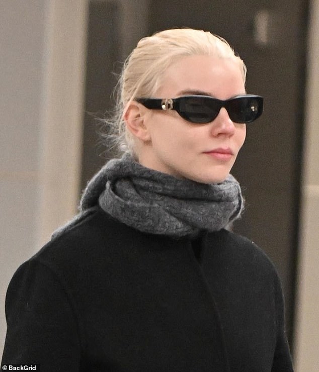 Anya scraped her signature platinum blonde locks into an updo and wore big black shades over her makeup-free complexion