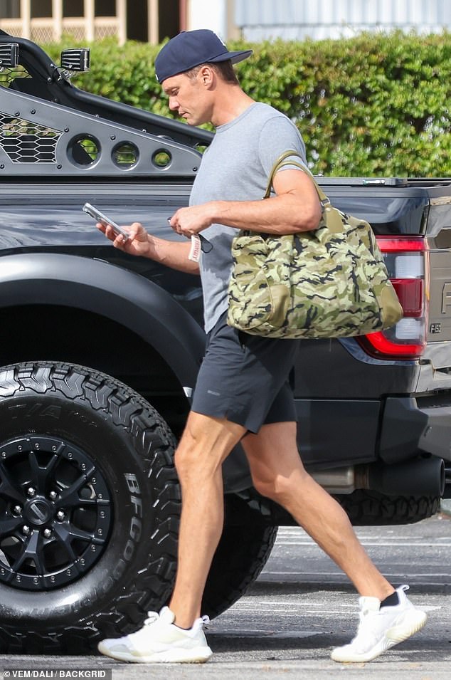 He protected his head with a navy blue baseball hat, which he wore backwards.  The athlete carried a sports bag with an army print on his shoulder