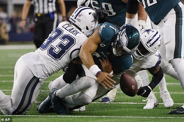 Donovan Wilson (right) forces a Jalen Hurts fumble during the first half of the game in Dallas