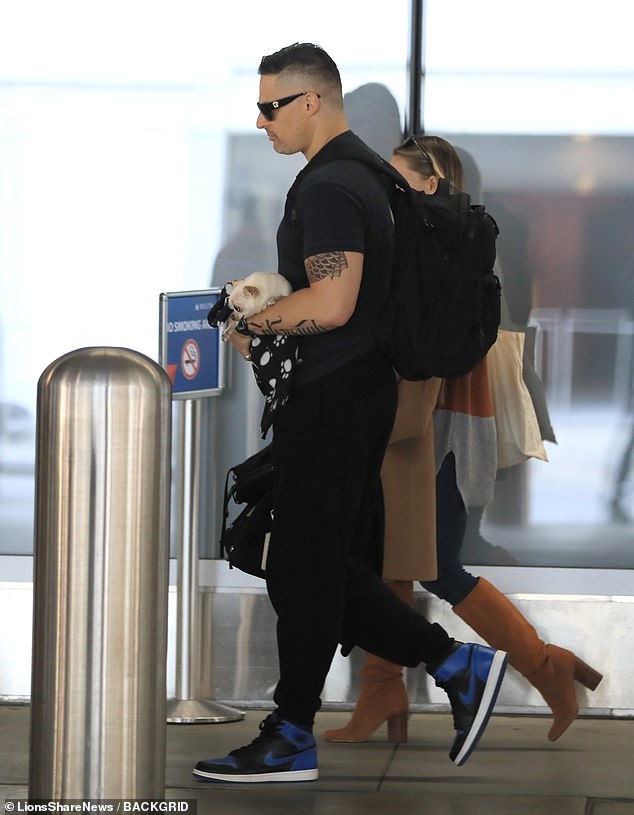 At the airport, the couple stayed close as they made their way to the terminal