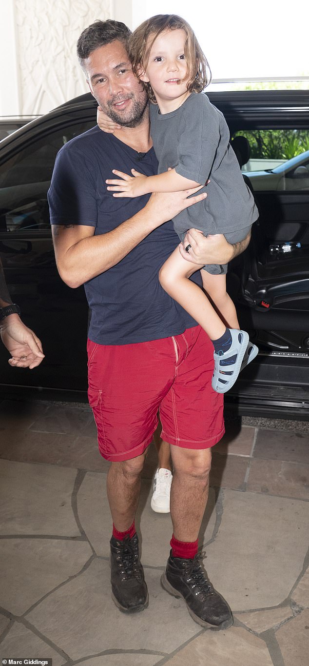 Still dressed in his jungle outfit, Tony held tight to Carson, who, along with his brothers, was given permission to be absent from school in Liverpool to fly to Australia to greet their father.