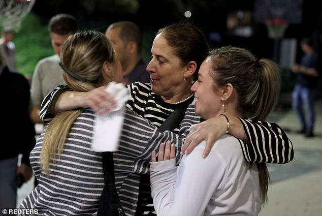 Chen Goldstein-Almog, a hostage released as part of a temporary ceasefire, hugs other community members from Kibbutz Kfar Aza, which was hit hard after the deadly October 7 attack