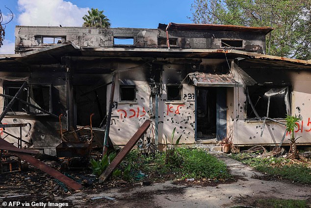 A photo shows bullet-riddled buildings damaged during the October 7 attack by Hamas militants on Kibbutz Kissufim in southern Israel