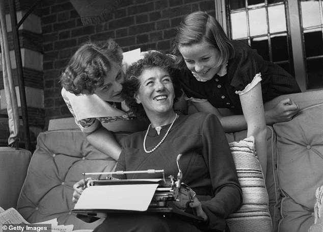 We see Blyton and her two daughters laughing together in 1949 as she sits with her typewriter