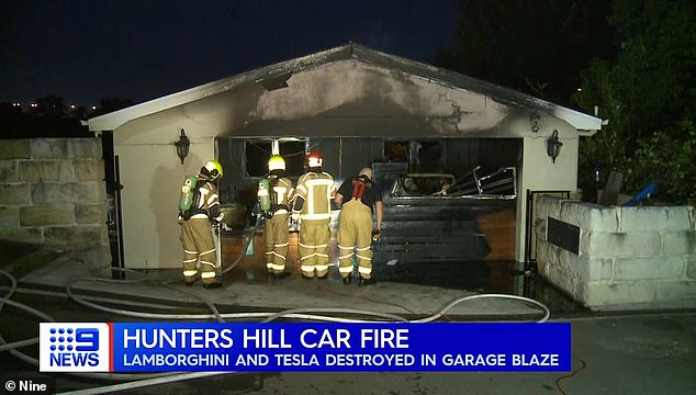 The garage door was almost completely destroyed as flames burned through the roofs of the two cars, exposing their interiors