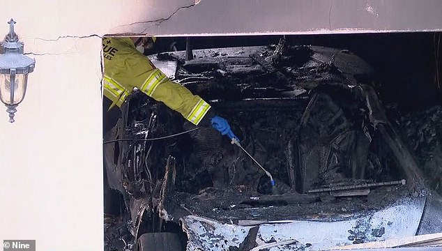 Police have indicated that the attack targeted the garage (picture shows one of the cars destroyed by the fire)