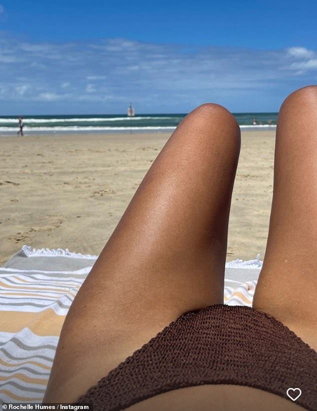 Rochelle showed off her incredible figure in a strapless brown bikini as she posed up a storm on the beach during a relaxing day out