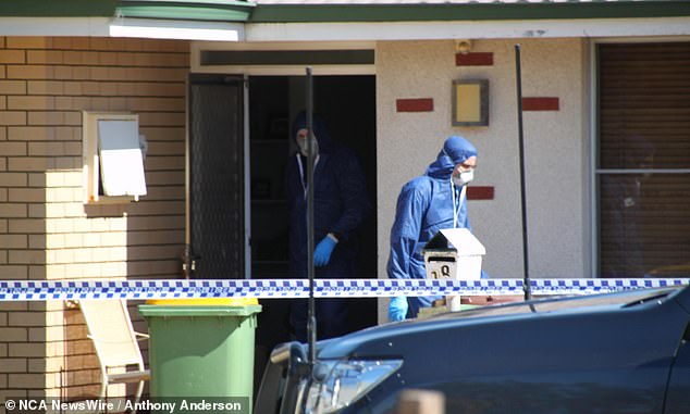 Forensic teams are photographed outside the family's home on Monday morning