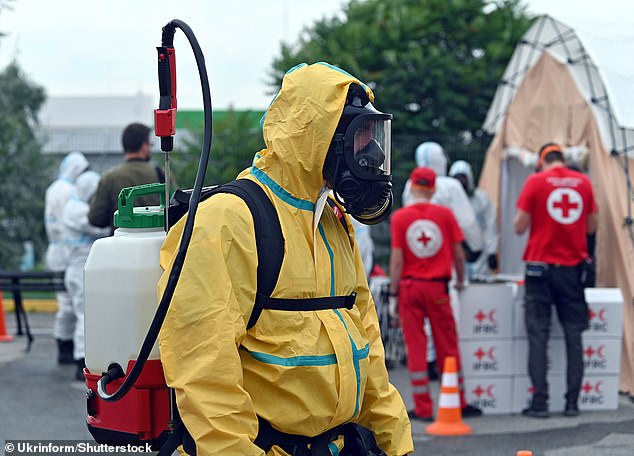 A worker in a hazmat suit and gas mask is pictured during the command and staff exercises to practice actions in an accident at the Zaporizhia nuclear power plant