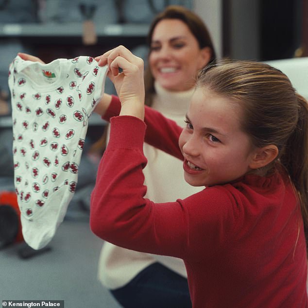 Charlotte diligently helped her mother during the visit to the baby bank - and the young royal was keen to show her enthusiasm