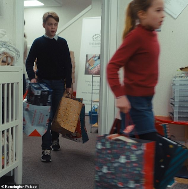 Kate's little helpers!  Prince George, ten, and Princess Charlotte, eight, carry what appear to be heavy bags full of Christmas goodies