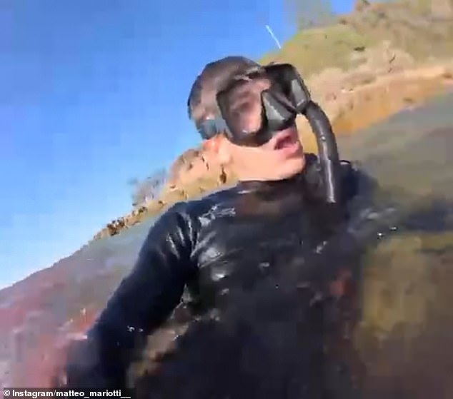 Mariotti screams for help on the shoreline as the water around him turns red