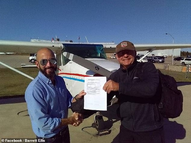 Mr Ellis poses with his instructor after obtaining his pilot's license on October 7