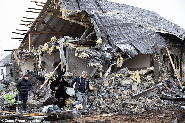 Kiev, Ukraine: Local residents remove items from their homes destroyed by the Russian missile attack on December 11