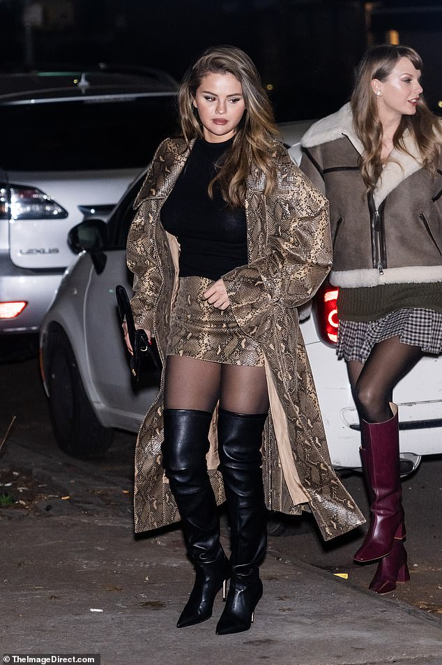 Gomez, 31, wore a matching animal print miniskirt and long coat, with a black turtleneck, sheer tights and black over-the-knee boots
