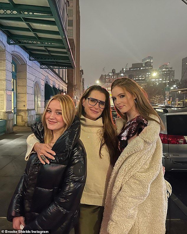 Brooke is seen here in New York with her arms around both of her daughters