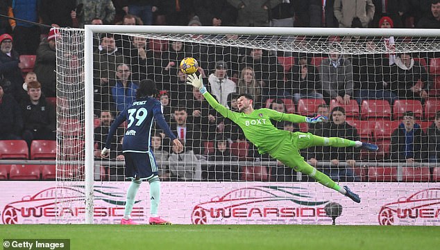 Leeds goalkeeper Illan Meslier dives to make a one-handed save in the first half on Tuesday