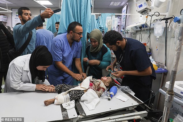 A seriously injured child is treated by doctors at Nasser Hospital in Khan Younis, Gaza, after Israeli attacks