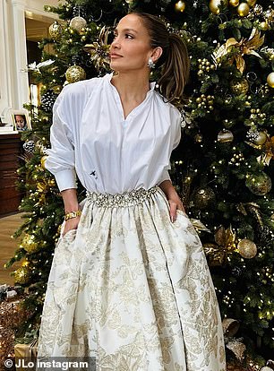 The simple top was paired with a glittering gold and cream brocade skirt with a butterfly pattern and a jeweled waistband