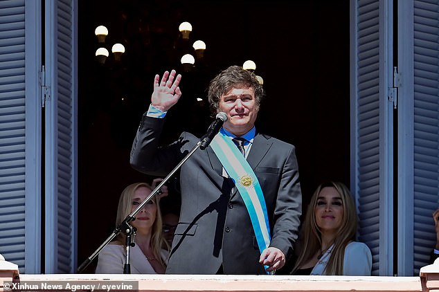 Milei greets the crowd from a balcony in Casa Rosada, the presidential palace in Buenos Aires