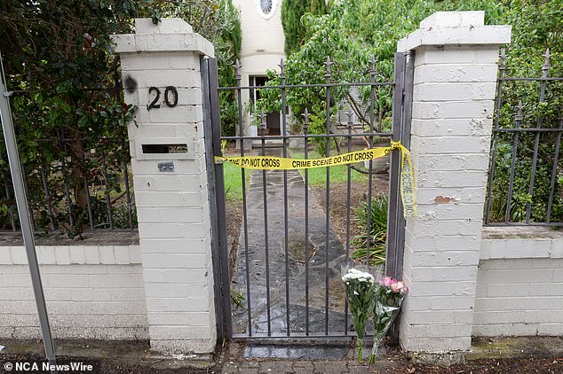 On the sidewalk in front of Dr. Yung's house, tributes begin to rise