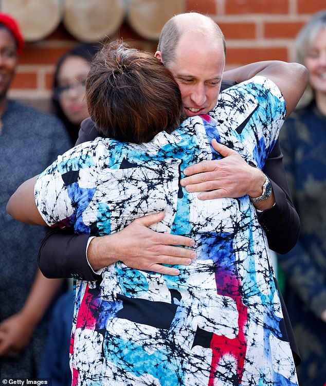 Prince William, Prince of Wales, embraces Professor Uzo Iwobi, founder of Race Council Cymru in Cardiff this year