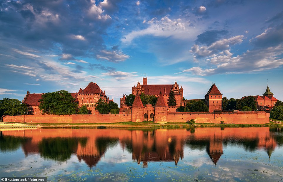 Malbork Castle is located on the east bank of the Nogat River in Malbork, about 40 kilometers south of the coast