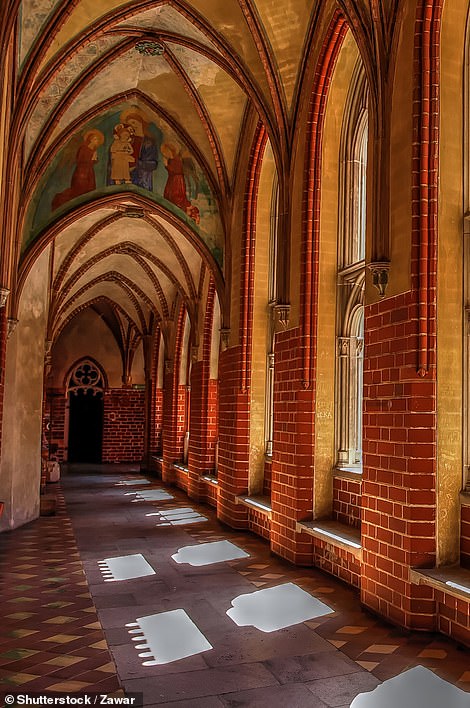 Tourists can wander the castle's Gothic corridors, as seen here