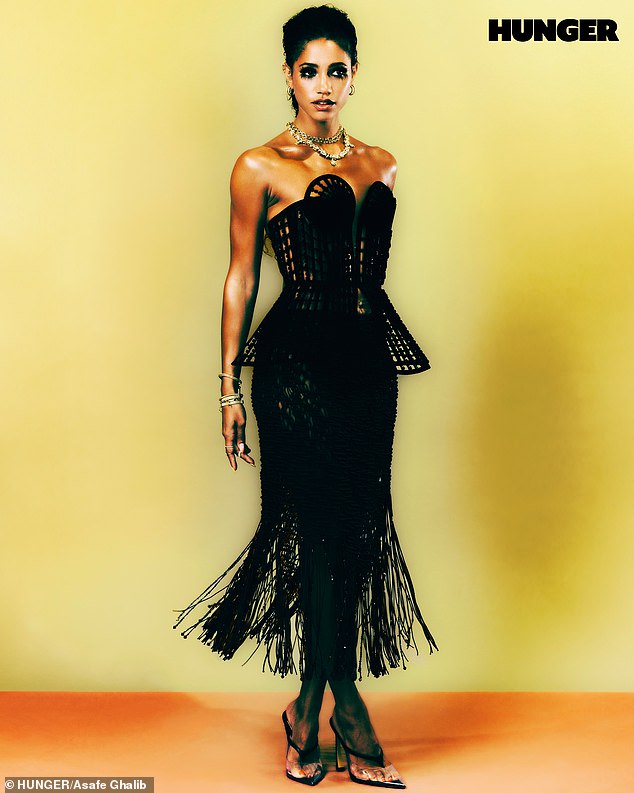 Vick showed off her flair for fashion as she modeled a black fringed dress with a structured corset