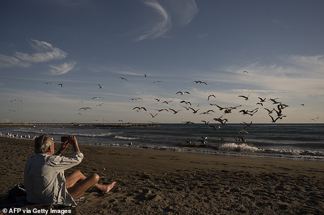 One man was spotted watching birds fly by on El Palo beach in Malaga