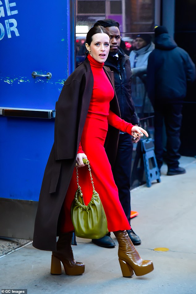 Claire opted for a vibrant pair of sky-high platform boots to complement her green handbag and red dress