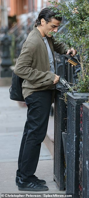 The Emmy-nominated actor was dressed in an olive coat over a gray shirt with black pants and black shoes as cameras rolled on the upcoming film.