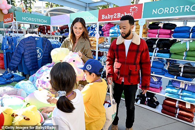 The couple - who share four children of their own - were pictured interacting with many of the children as they excitedly picked out presents