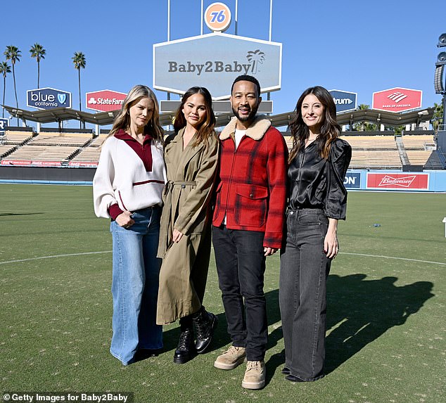 Teigen, Legend and Baby2Baby's co-CEOs Kelly Sawyer Patricof and Norah Weinstein posed for a photo on the court