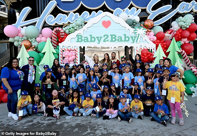 The children in attendance were each given a blue Dodger hat and posed for a photo featuring this year's celebrity volunteers