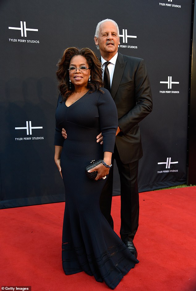 The media mogul joked that she hoped her longtime partner Stedman Graham, 72, would follow suit after Barrymore was seen repeatedly caressing Oprah's arm and hand during the exchange.  Pictured in Atlanta in 2019