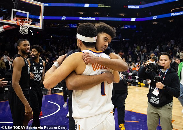 Cam Johnson and former teammate Booker hugged after the game Wednesday night