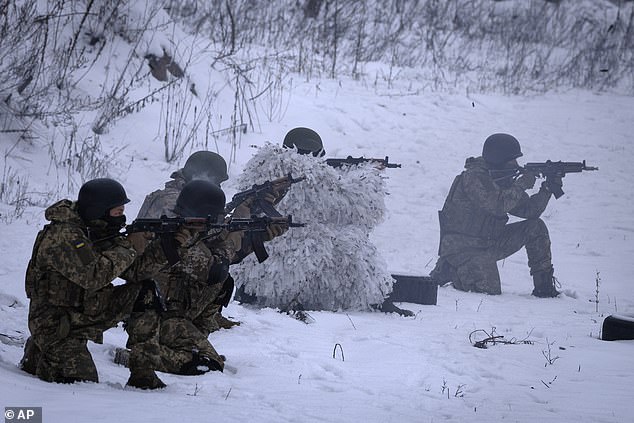 Members of the pro-Ukrainian Russian ethnic Siberian battalion exercise during a military training near Kiev, Ukraine, Wednesday, December 13