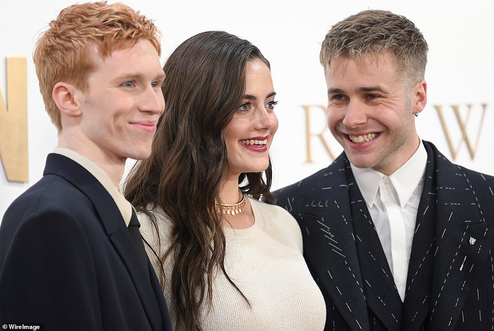 The final six episodes of The Crown dropped on Netflix today.  Pictured: Luther Ford, Meg Bellamy and Ed McVey – who play Harry, Kate and William – at the finals celebration this month