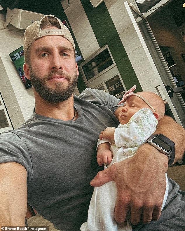 Dad mode: He previously joked to his social media followers that he was getting 'some practice reps' while holding a baby in September