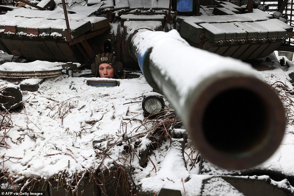 A Ukrainian soldier looks out from a tank near the city of Bakhmut, Donetsk region, on December 13