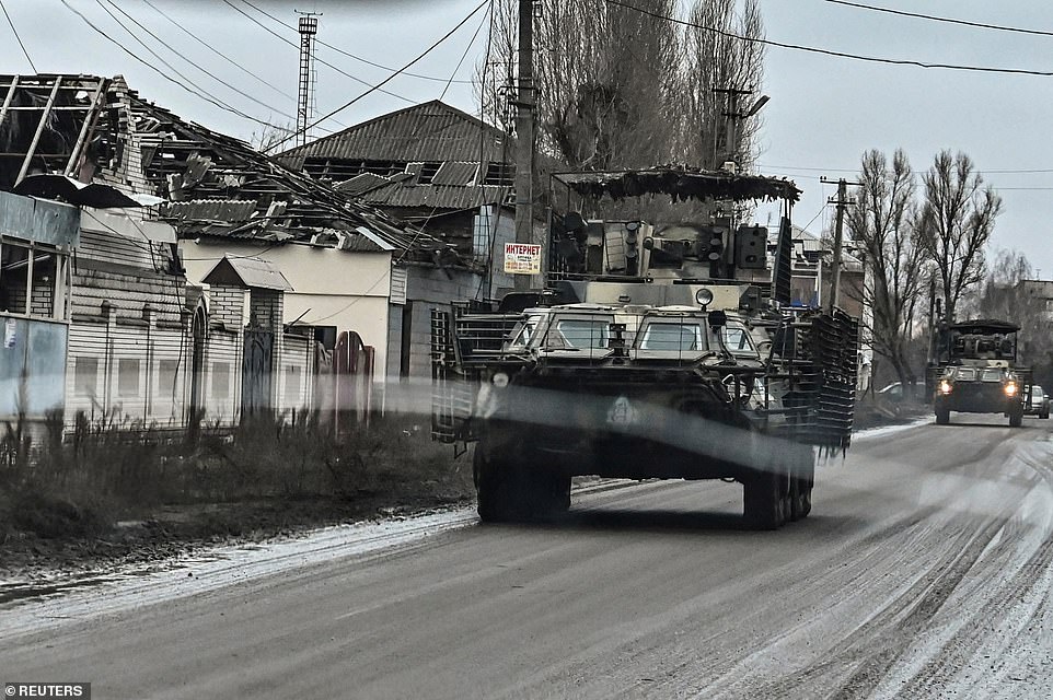 Ukrainian soldiers drive BTR-4 armored personnel carriers along a road in the city of Orikhiv, amid the Russian attack on Ukraine, Zaporizhia region, December 13