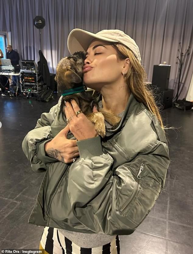 The Anywhere star also shared an adorable photo of her cuddling a dog while wearing a quirky fit in striped shorts and yellow pants