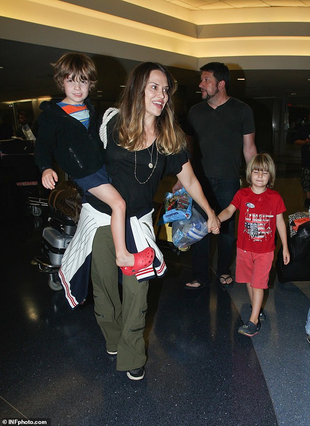 Sources close to the exes of Sheen, 58, and Mueller, 46, have given a very different story about their 14-year-old sons Bob and Max, Page Six reported Thursday;  Mueller is seen with her children at LAX Airport in August 2014