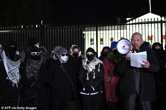 On Thursday evening, dozens of masked White House staffers (above) stood outside the gates of 1600 Pennsylvania Avenue demanding an 