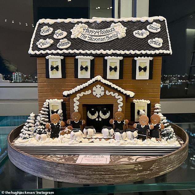 Hugh's gingerbread house last year had five gingerbread figures and dogs outside the front with the names of each family member listed