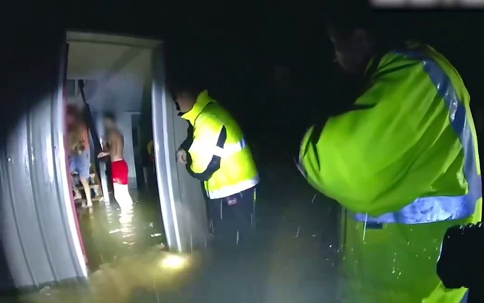 Officers were seen helping several residents of the Mossman home after Cyclone Jasper caused major flooding in the city